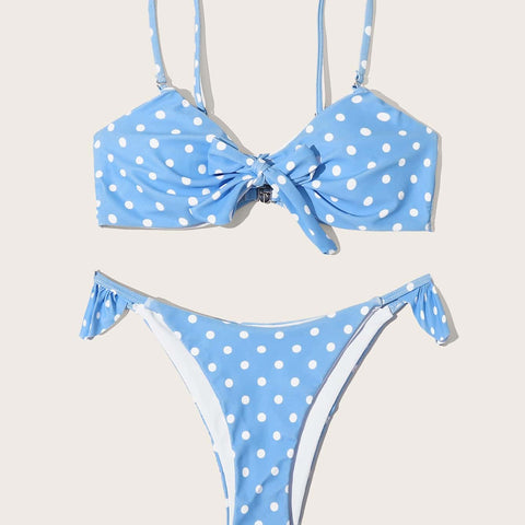 Blue polka dot bikini set laid flat with adjustable tie-side bottoms
