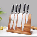 Magnetic wood knife holder with five chef knives displayed on countertop