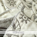  Close-up of beige cotton boho throw blanket showing detailed stitching and tribal gray pattern with soft fabric texture.