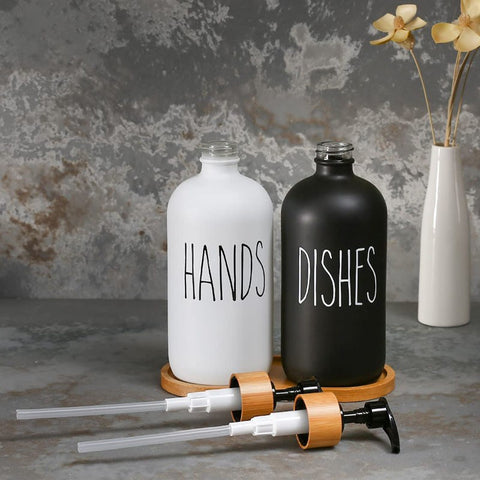 Hands and dishes dispensers with black and white matte finish on countertop