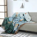 Mermaid couch blanket casually draped over grey sofa