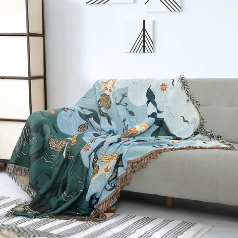 Mermaid couch blanket casually draped over grey sofa