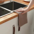 Hand drying towel over kitchen counter sink