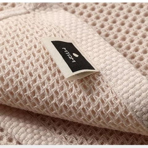 Close-up of fabric tag on textured honeycomb towel