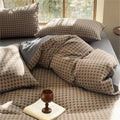 Brown and gray Milano houndstooth cotton bedding set with duvet cover arranged on bed