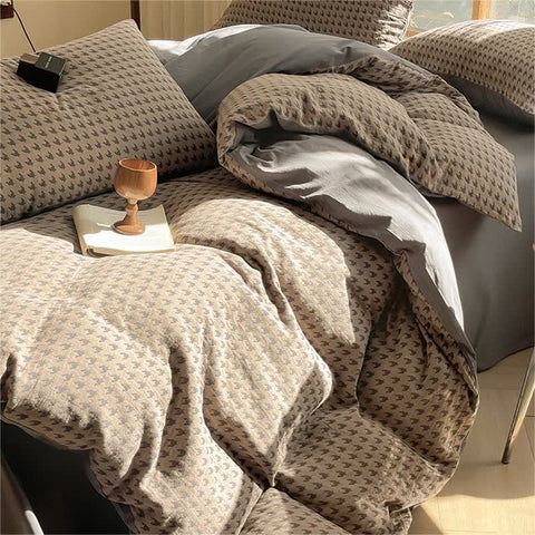 Side view of Milano houndstooth brown and gray double gauze cotton bedding set with duvet cover