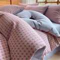 Close-up of Milano houndstooth pink and gray cotton bedding set with soft duvet cover