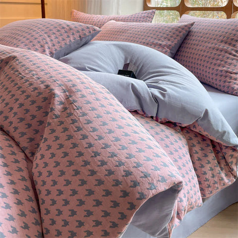 Close-up of Milano houndstooth pink and gray cotton bedding set with soft duvet cover