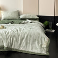 Minimalist bedroom with soft green cotton quilt and two matching pillows