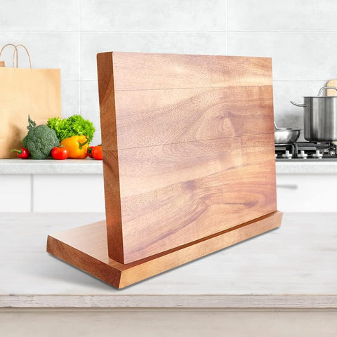 Minimalist magnetic knife holder on white kitchen counter
