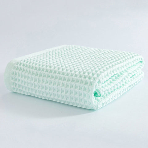 Mint green waffle bath towel folded neatly on display