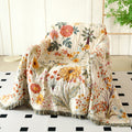 Cotton floral couch cover blanket on armchair with boho interior