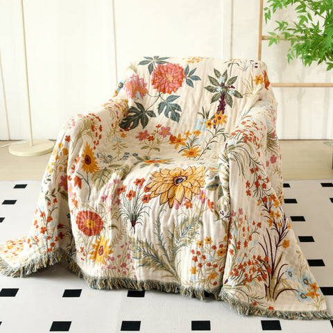 Cotton floral couch cover blanket on armchair with boho interior