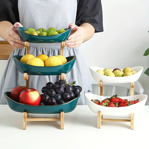 Modern 3-tier bamboo and ceramic fruit basket stand displaying grapes and citrus fruits