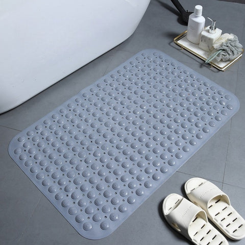  Gray rectangular anti-slip mat beside bath slippers