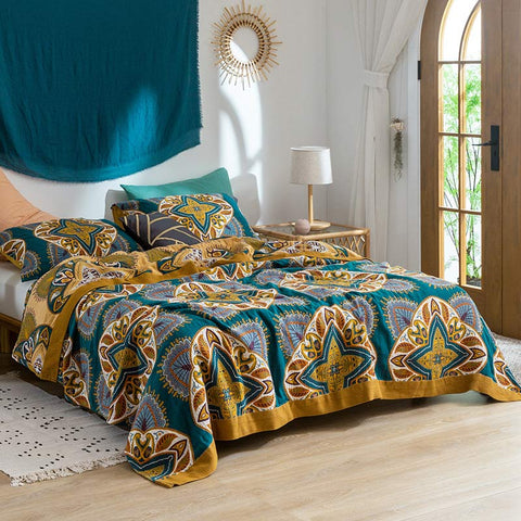 Morocco quilt with golden trim styled in boho bedroom