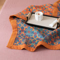 Decorative cotton quilt with floral pattern on a pink surface