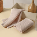 Beige and blush microfiber towels styled with ceramic vases