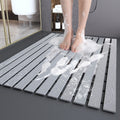 Non-slip quick-dry shower mat in use with foam and water drainage