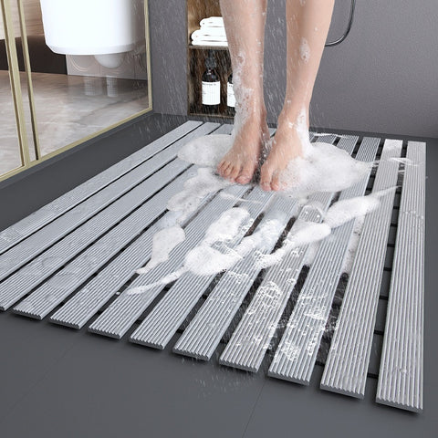 Non-slip quick-dry shower mat in use with foam and water drainage