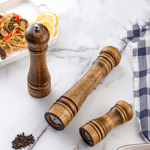 Three sizes of oakwood grinders on napkin background