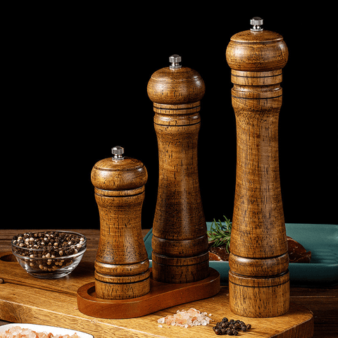 Complete oakwood spice grinder set in dark background