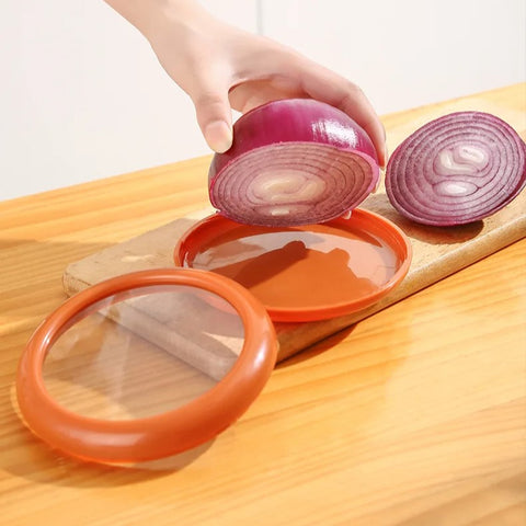 Red onion placed in orange food pod on table