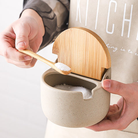 Person opening salt jar with built-in spoon