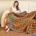 Full view of orange and blue cotton quilt on bed