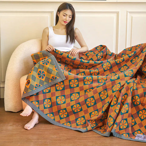 Full view of orange and blue cotton quilt on bed