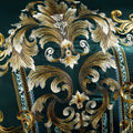Zoomed-in golden floral embroidery on emerald cotton fabric