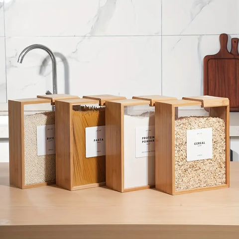 Set of wooden storage bins labeled with different food items on a kitchen counter.