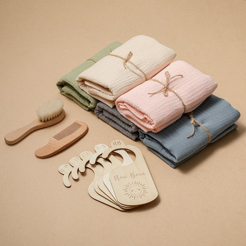 Five baby towel gift sets in assorted pastel colors with wooden accessories