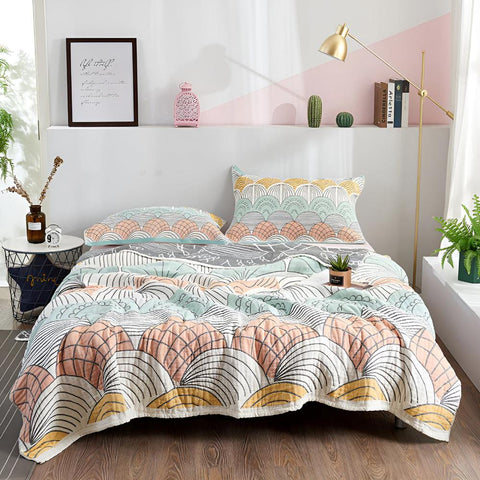 Pastel elegance cotton quilt spread neatly on bed in bright bedroom with coordinating pillows and soft natural light