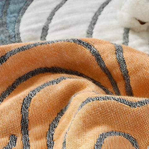 Close-up view of pastel elegance cotton quilt showing detailed scallop pattern in soft peach, mint, and beige tones