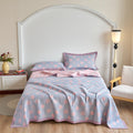 Soft cotton gauze quilt set with pastel polka dots on king bed