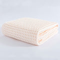 Folded peach waffle towel with breathable cotton texture