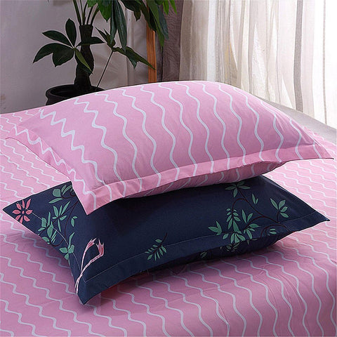 Matching pillowcases with colorful pink and navy patterns from duvet cover set