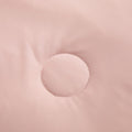 Detailed view of circular stitching on soft pink ice silk quilt fabric