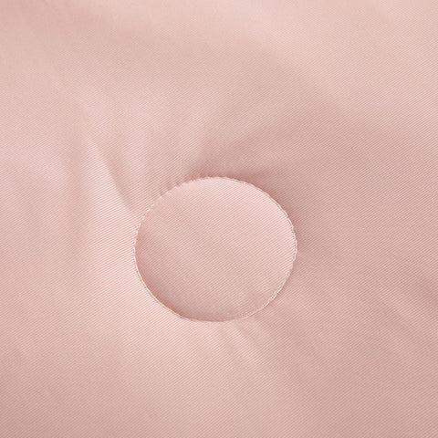 Detailed view of circular stitching on soft pink ice silk quilt fabric