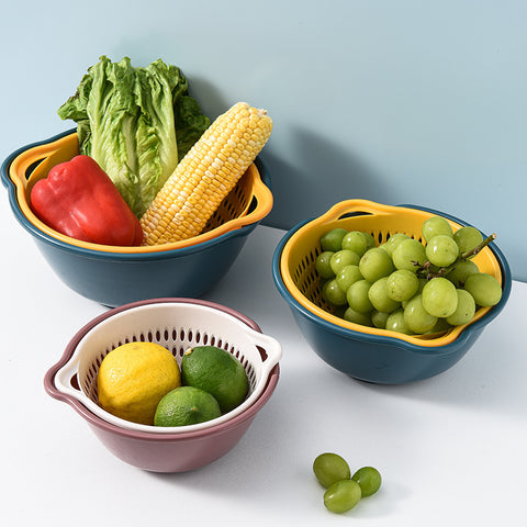 Set of three colanders with fruits and vegetables on a light blue background