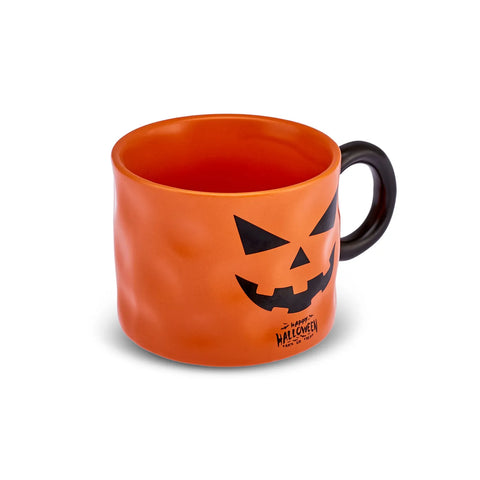 Orange mug with a black jack-o'-lantern face design on a white background