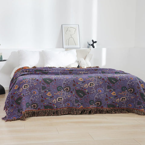 Purple boho cotton throw blanket spread on bed, showcasing cozy bedroom decor.