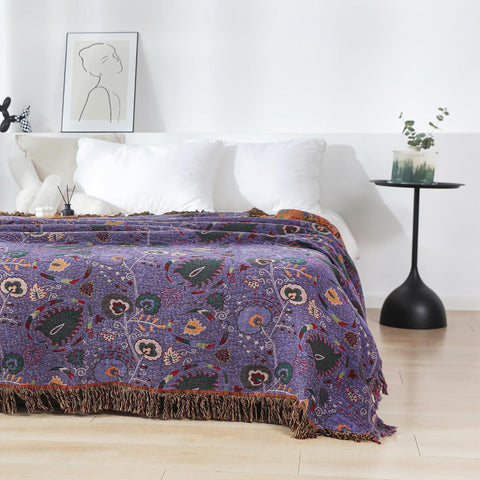 Another angle of purple boho cotton throw blanket on bed, highlighting fabric texture and style.