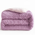 Folded purple textured blanket on a white background
