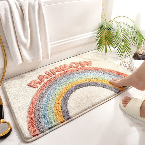 Colorful rainbow bath mat with soft texture and playful lettering, perfect for brightening up a kids’ or modern bathroom