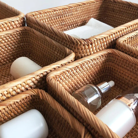 Wicker baskets with skincare products on a neutral background