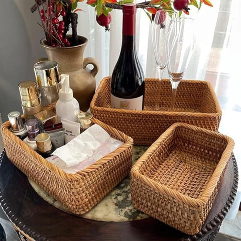 Woven baskets with various items including a bottle of wine on a table.