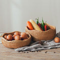 Rustic rattan vegetable baskets on wood surface with carrots and eggs