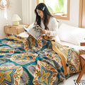 Woman reading under soft reversible Moroccan quilt